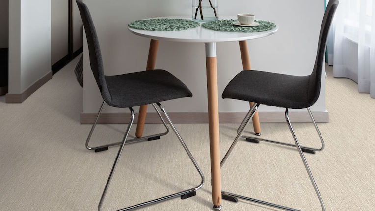 commercial carpets with a small side table and chairs