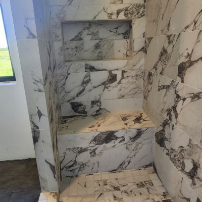 stone tile with stone bench and niche built in waterproof custom shower