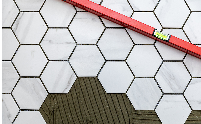 marble hexagon tile flooring being installed